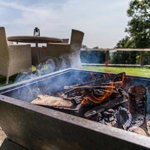 Get cosy round the open firepit at The Clubhouse bar, Treehouse Hotel in Kent