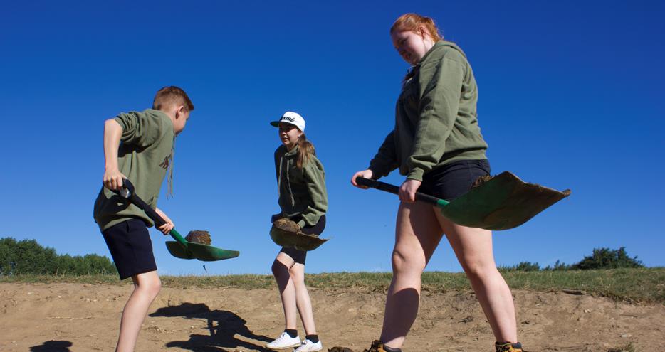 Keeper Academy students mucking out at Howletts Wild Animal Park in Kent