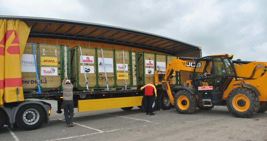 The rhinos are loaded onto a DHL truck in their travel crates to begin their journey back to the wild