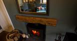 Cozy fireplace in the snug at Rhino Cottage