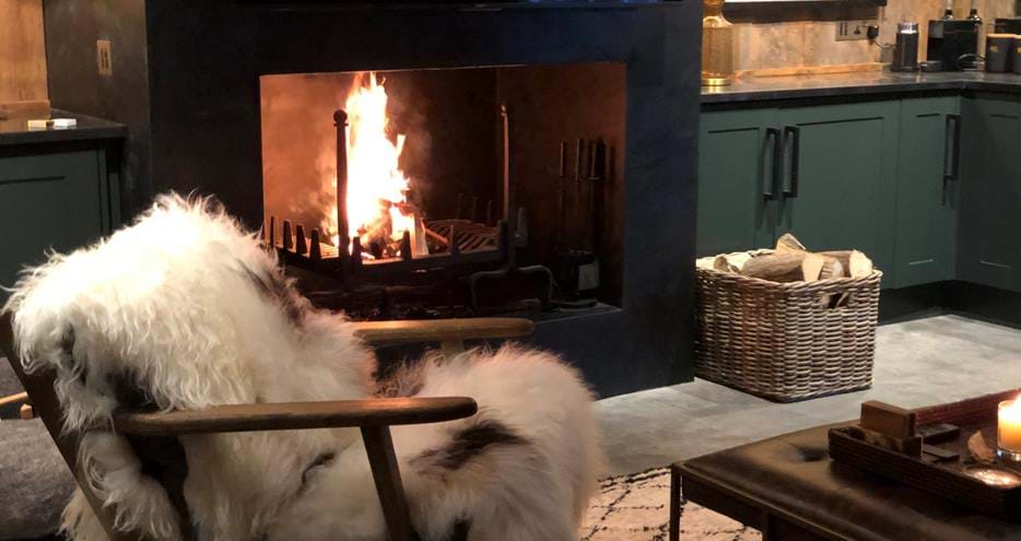 Relax in a cozy armchair by the fire at ion Lodge at Port Lympne Hotel and Reserve in Kent