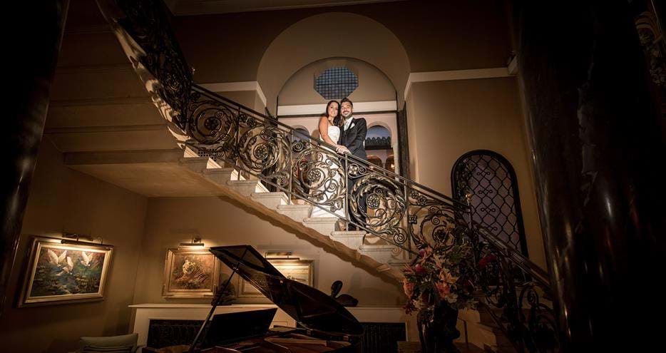 Beautiful wedding photography on the grand staircase at Kent wedding venue, Port Lympne Hotel & Reserve