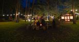 Toasting marshmallows by the firepit at Pinewood glamping pods at Port Lympne Hotel & Reserve in Kent, UK