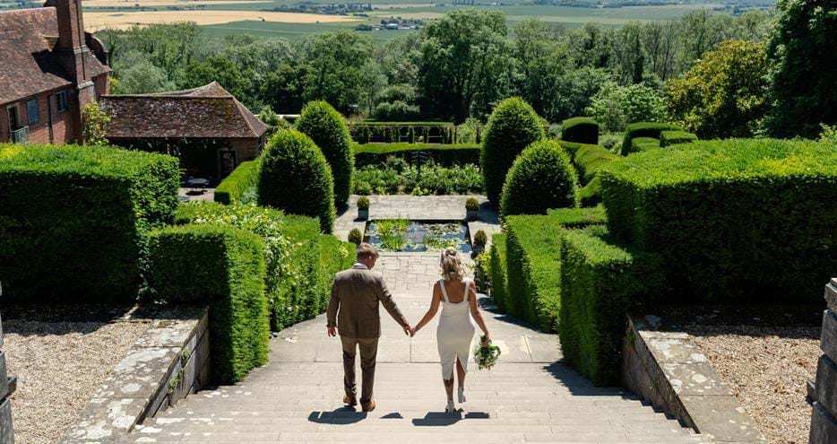 Newlyweds on the Trojan Staircase at Port Lympne Hotel and Reserve wedding venue in Kent